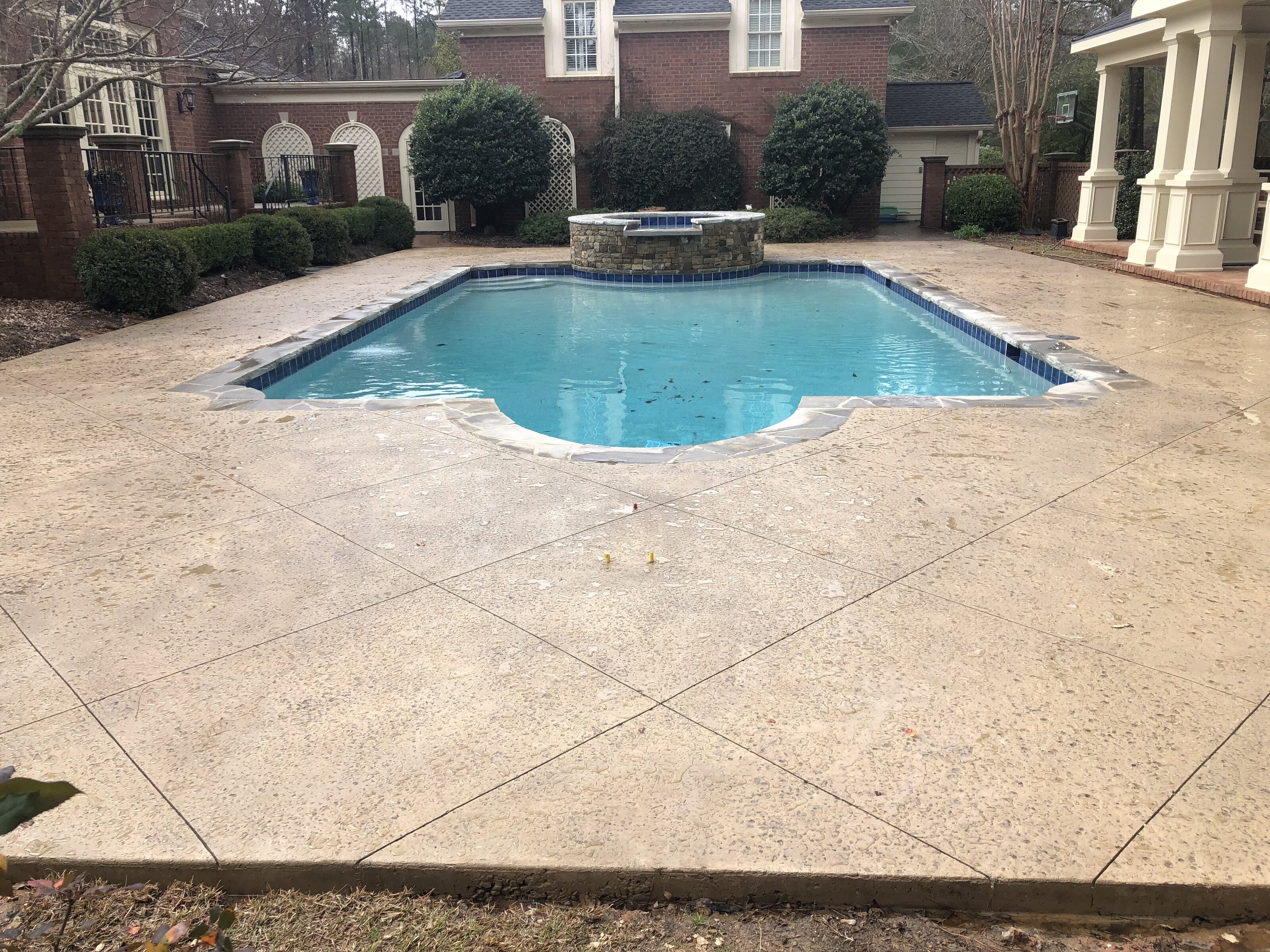 Inground pool renovation near Warner Robins GA — completed spa and pavilion with new blue waterline tile by Mid State Pools