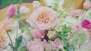 Super 8 film still of pastel wedding florals with garden roses and seasonal blooms — captured at a Cape Cod wedding by a vintage wedding videographer.