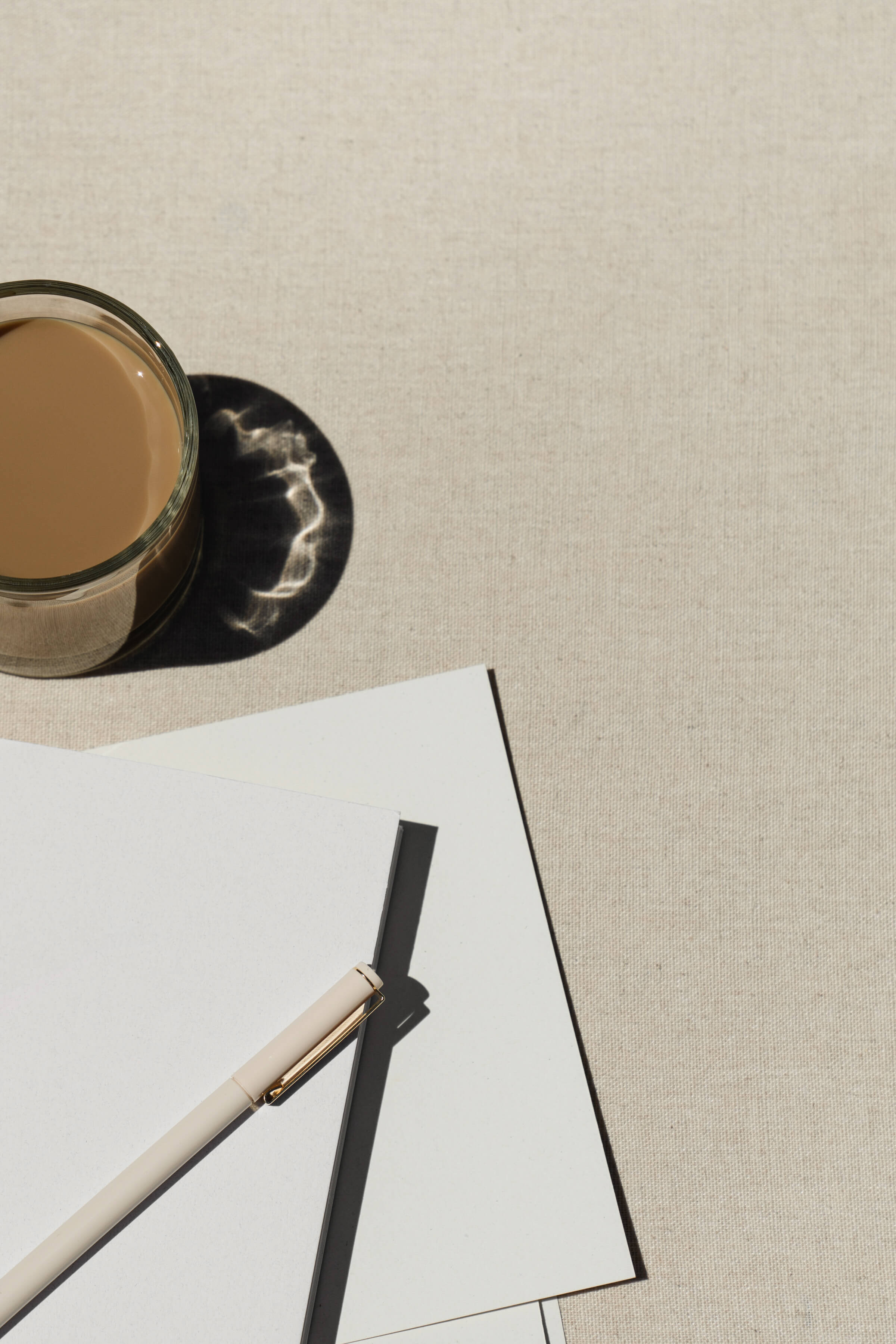 Website copywriter's cup of coffee, paper, and pen