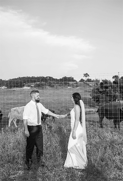 GIF of bride and groom dancing in a field by buffalo on their wedding day