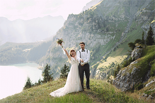 Couple pops champagne at vow renewal in the mountains