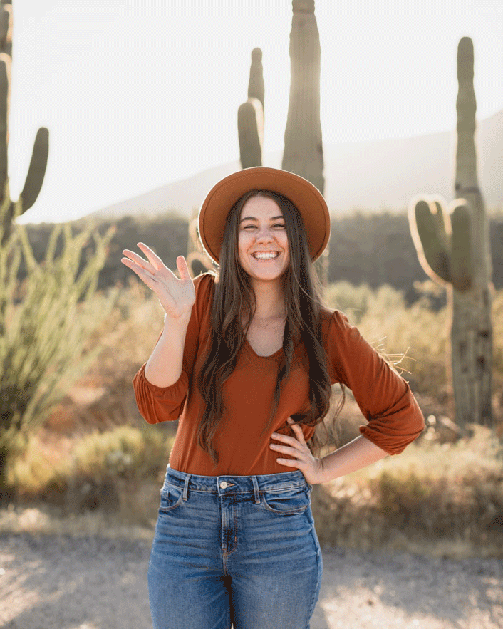 GIF Image of a wedding photographer smiling and waving to the camera in the desert