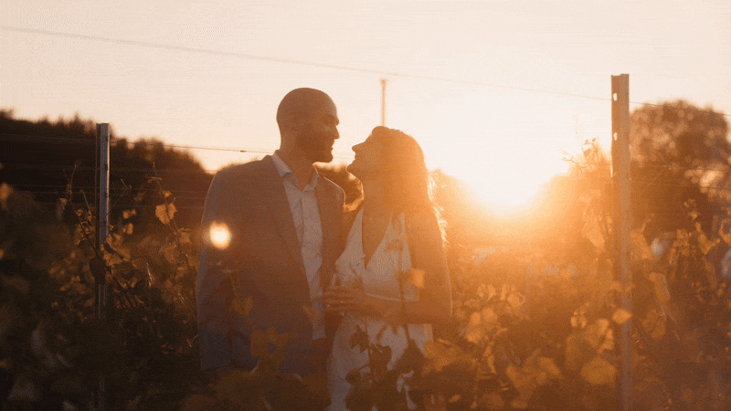 Couple share a kiss during golden hour on their wedding day. Captured by untraditional oxfordshire wedding videographer