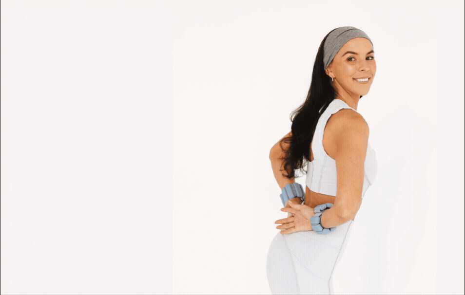 GIF of women in a blue outfit with bala bands on wrists posing for a picture at a fitness shoot