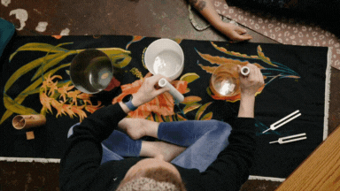GIF of Alex Paige doing sound baths on the floor