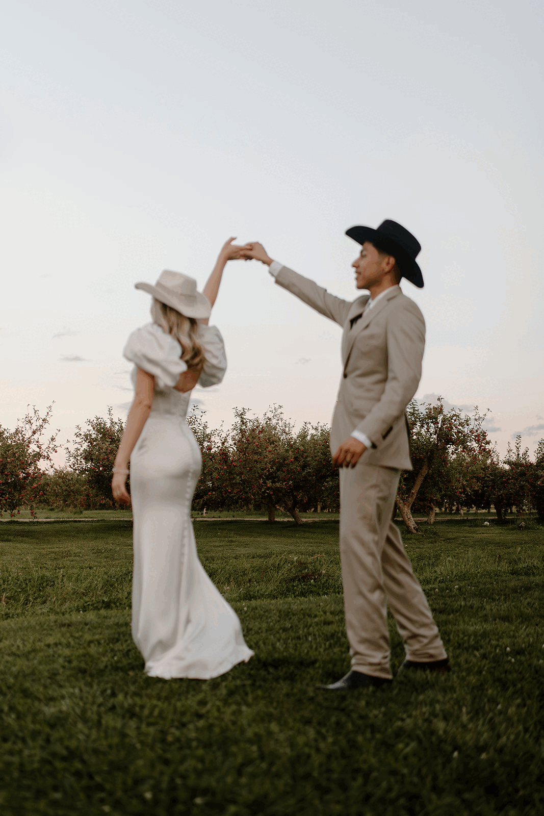 groom swirling bride and kissing her
