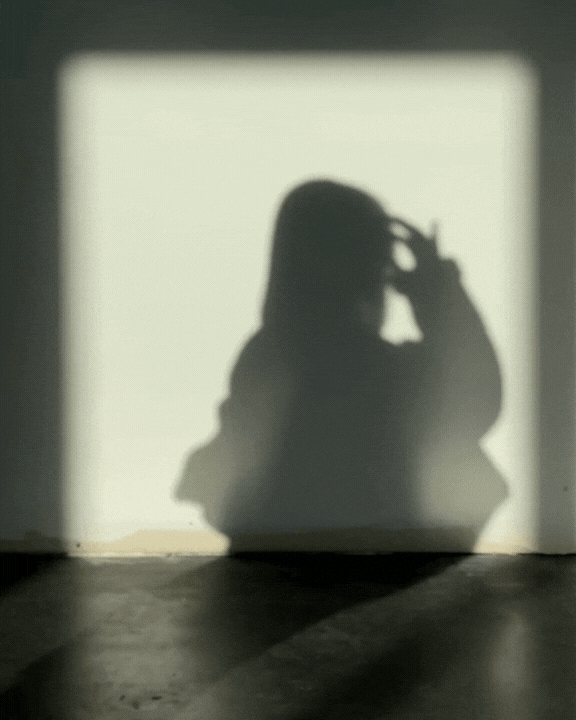 Stylized shadow animation of a woman removing her sunglasses, creating a sleek and artistic effect for modern brand storytelling.