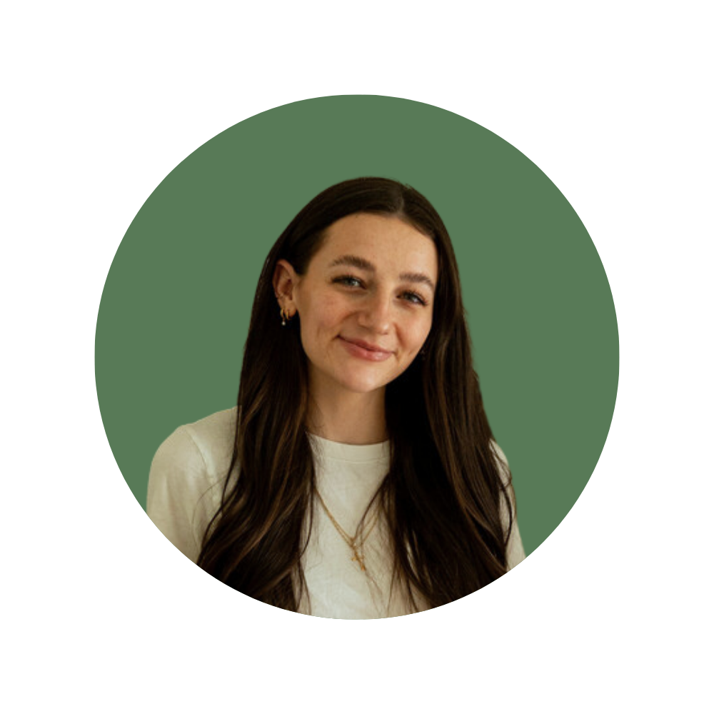 Abi G., a Web Designer Library member, smiling with long brown hair, wearing a cream top and gold jewelry.