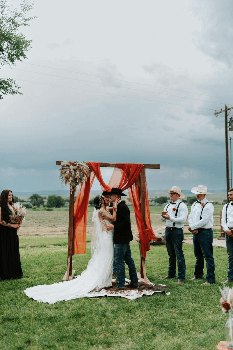 joyful couple sharing a first kiss at their Wyoming wedding