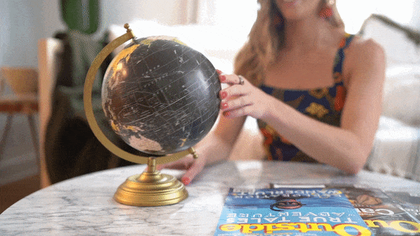 Digital nomad and designer spins a globe to decide what country to work remotely in next