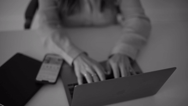 A woman typing on a laptop