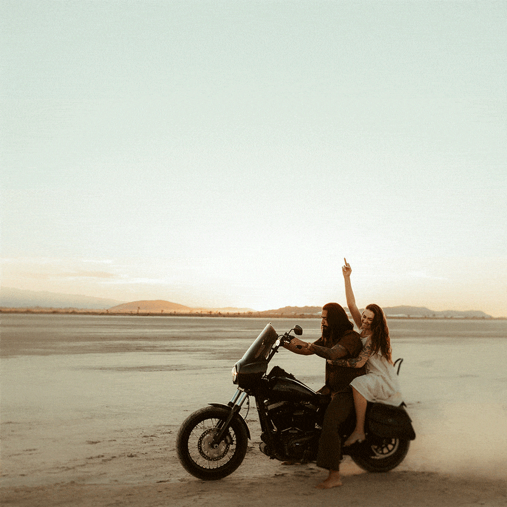 couple riding on motorcycle in the middle of dry lake bed by cincinnati elopement photographer