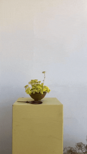 Gif of Natalia making a yellow floral design piece.