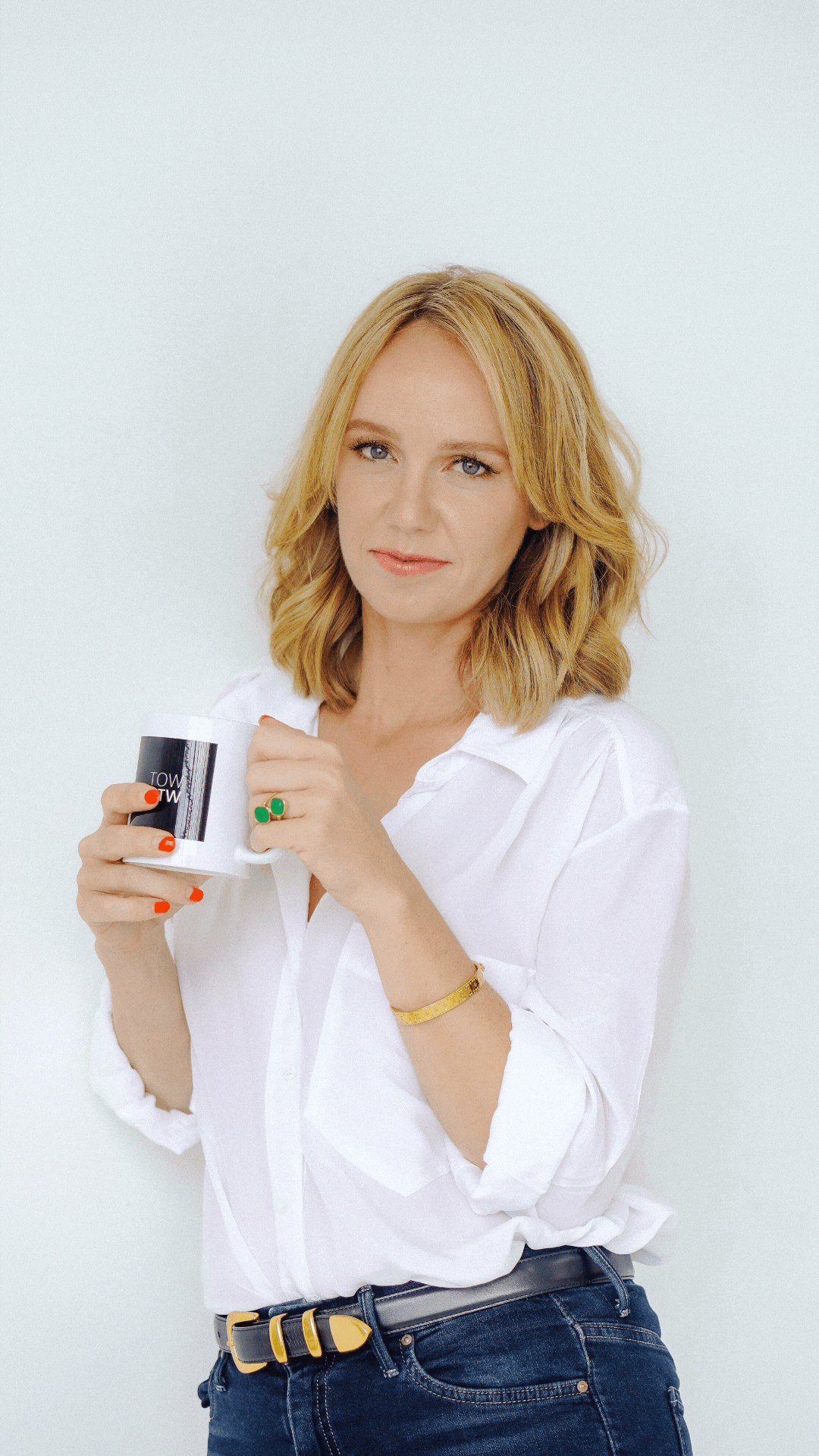 woman smiling holding coffee cup