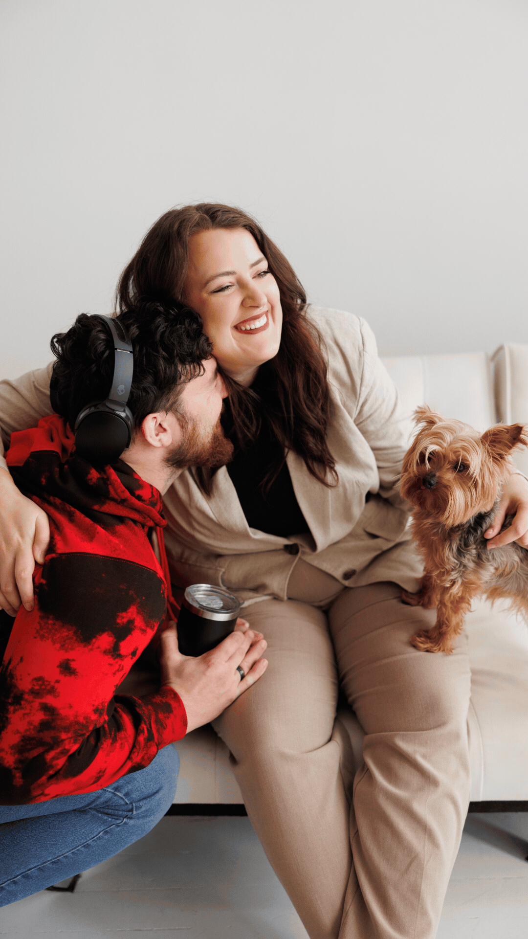 This is a gif of Mariah from Moonlight Design Studio with her husband and dog giggling on a couch.