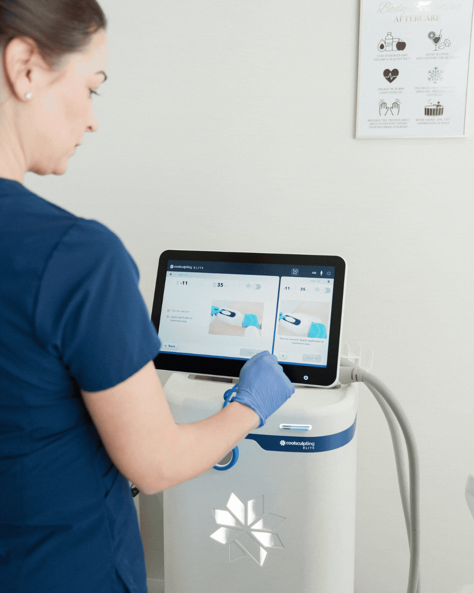 CoolSculpting services in Dallas with a male patient lying on a stretcher while the specialist explains the procedure next to the CoolSculpting machine.