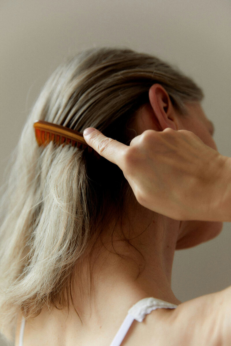 woman combing her hair