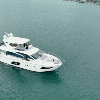 Bride and groom lounge on a yatch after their beach wedding ceremony 