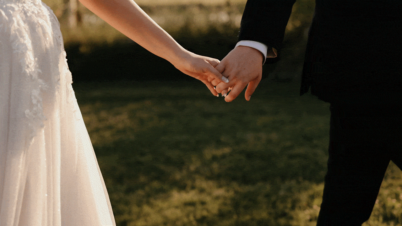 Bride And Groom Holding Hands During Sunset