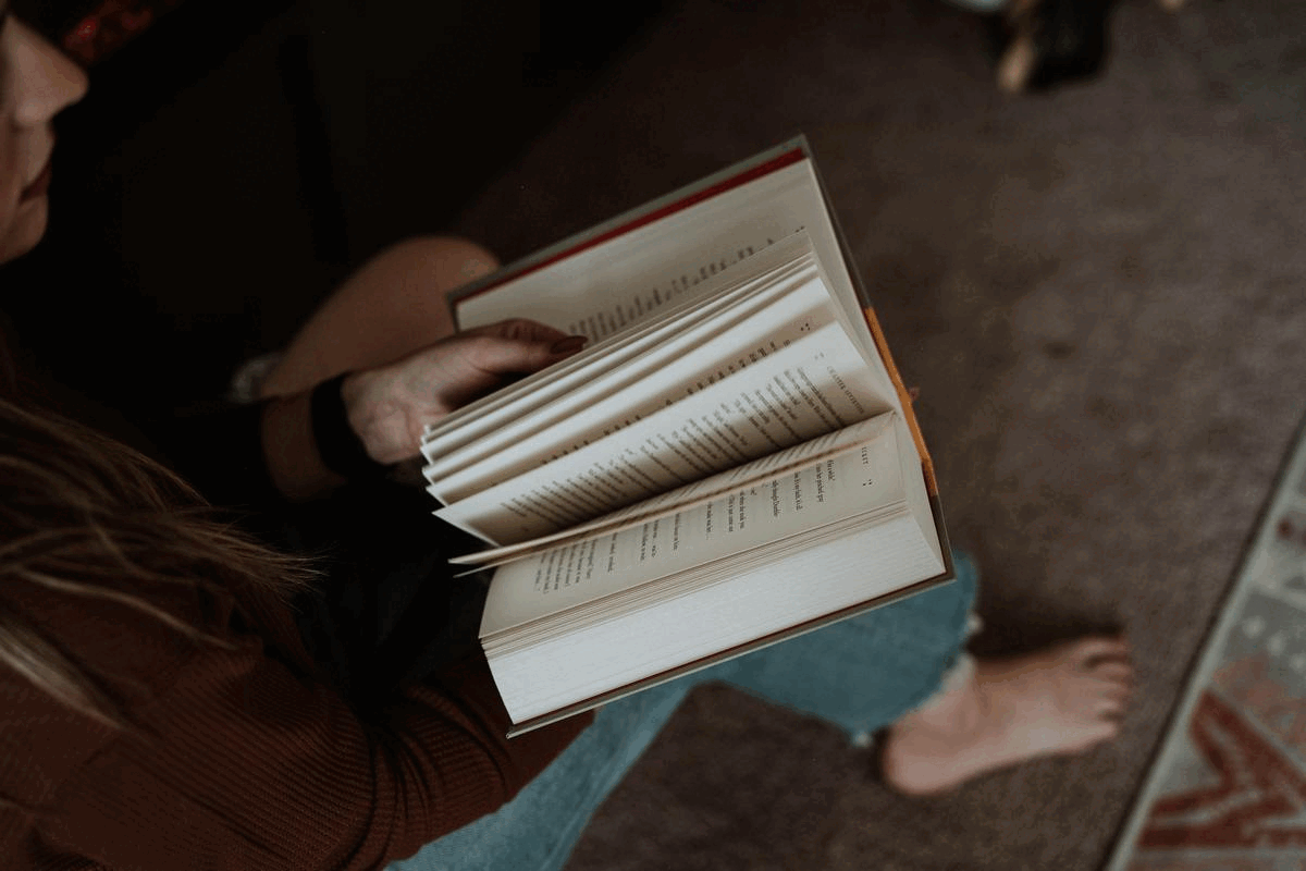 woman flips through book