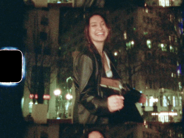 woman smiling with a camera