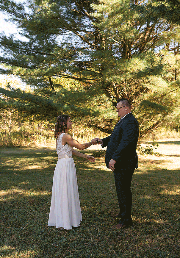 GIF of bride and groom dancing under trees at their wedding