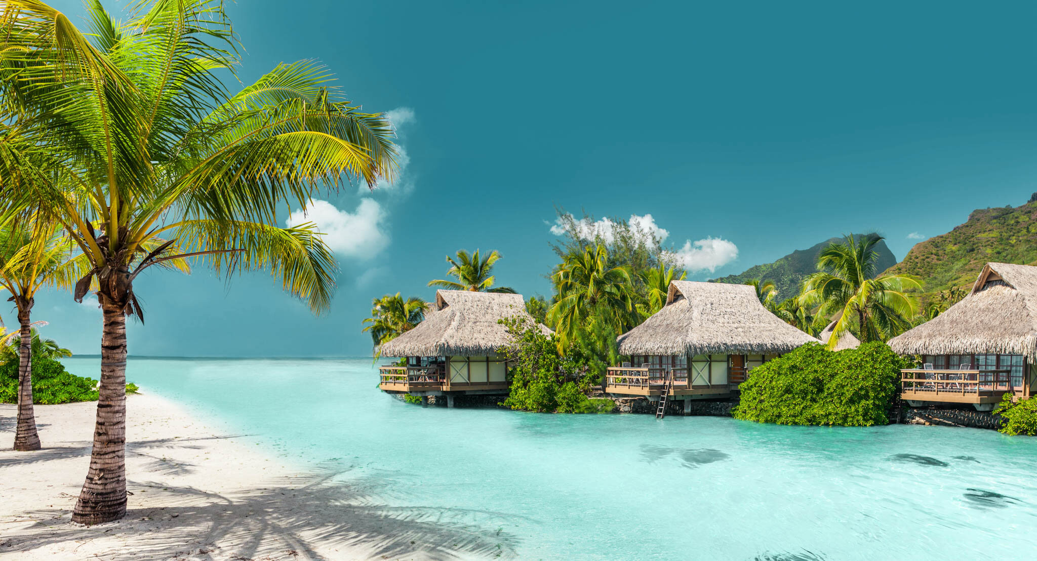 Mom and child on a balcony overlooking the sea