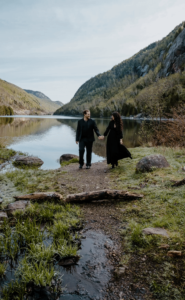 couple walks in front of lake