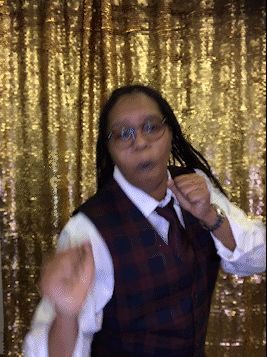Boomerang of a person in a photo booth with gold background