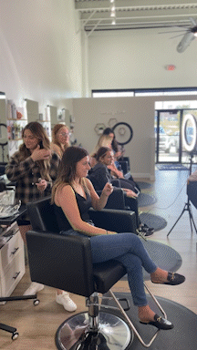 GIF panning through a salon filled with stylist and clients.
