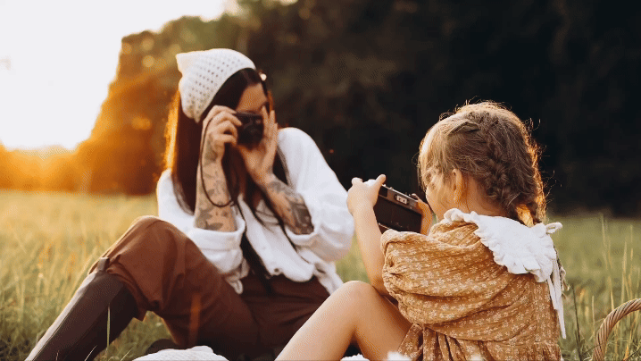 mother and daughter taking photo of each other in a field