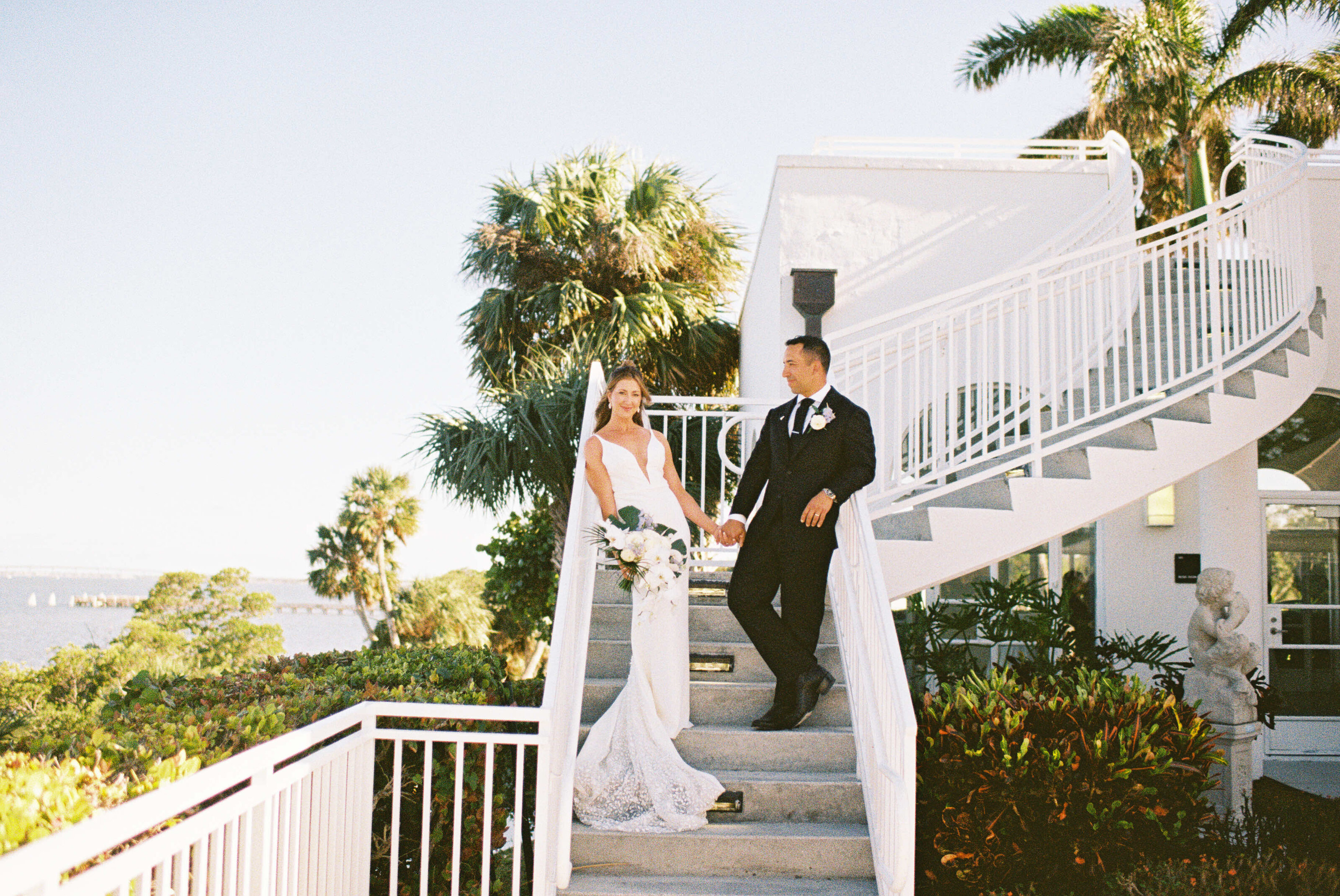 A man and woman are standing on stairs outdoors.