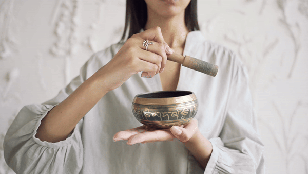 Women making sound from a bowl