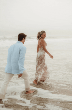 GIF of a couple spinning each other playfully during their beach engagement session in Pennsylvania