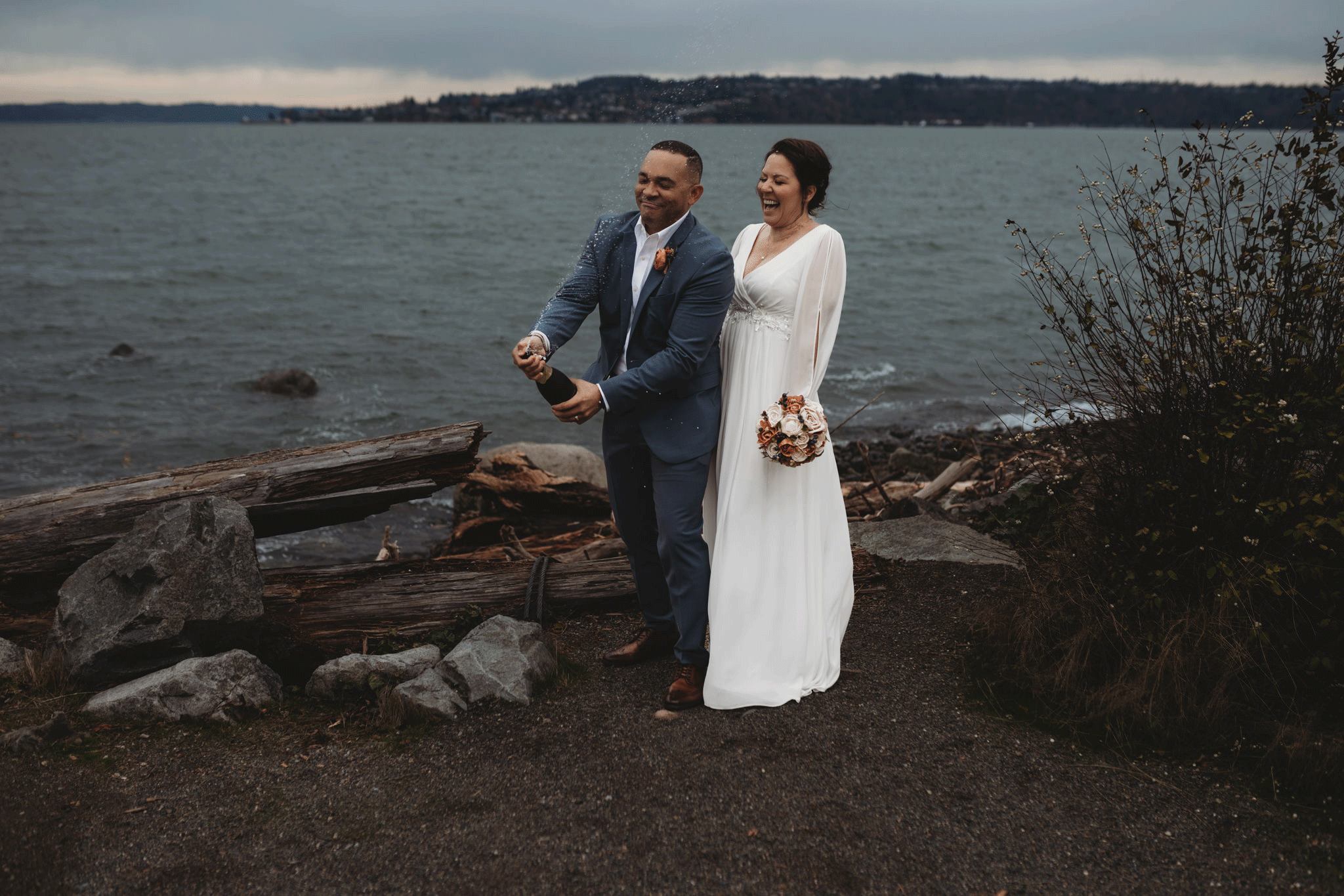 Couple popping champagne in Olympia WA Elopement