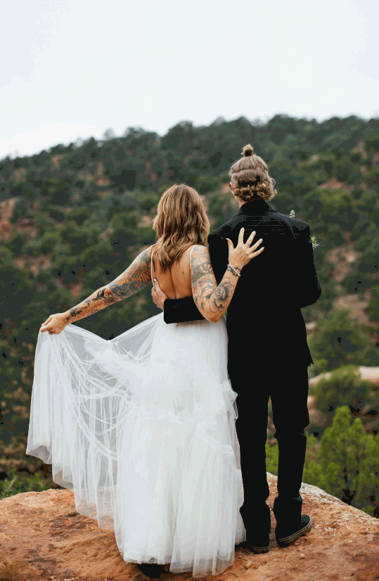 Bride and Groom overlooking Mountains at Garden of the Gods in Colorado