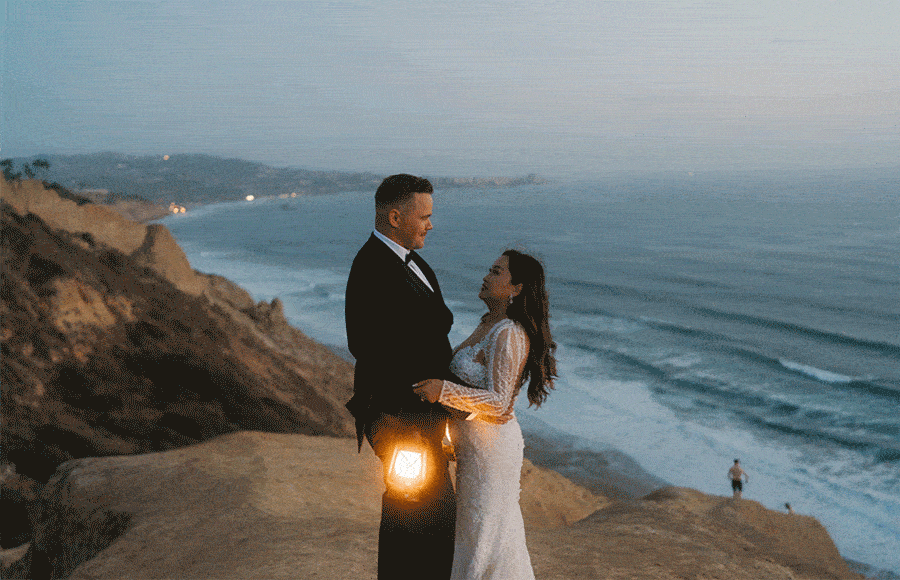 couple walking beach cliffs