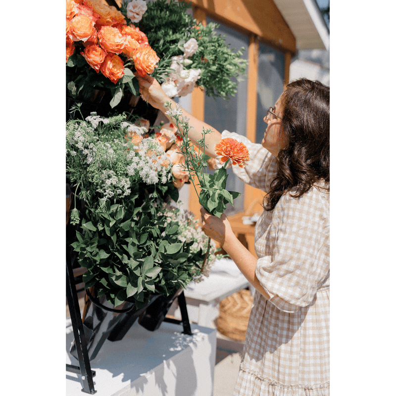 brand photos Columbus Ohio of woman working at a venue behind the scene on floral decor captured by Columbus photographer