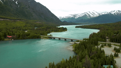 Scenic view of the Kenai River flowing through the rugged landscape of Alaska's Kenai Peninsula.