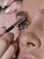 Makeup artist applying eye shadow