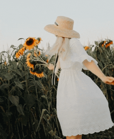Girl spinning freely with sunflower